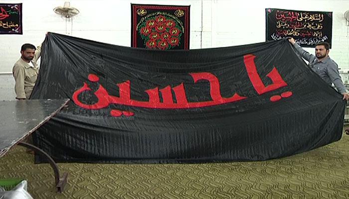 Photo of Banner of Imam Hussein, peace be upon him, finished to be raised with special ceremony