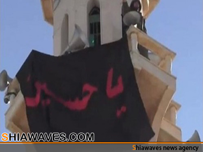تصویر اهتزاز پرچم حرم امام حسین علیه السلام درشهر القصیر +فیلم